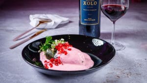 Chile en nogada rosa, reinterpretación de un clásico que brilló junto al merlot de Xolo Vino, vino de gran estructura y notas de frutos maduros.